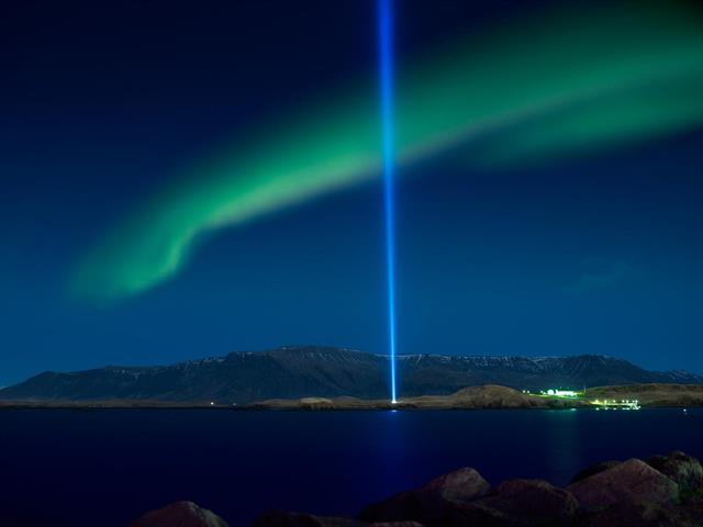 Northern lights over Reykjavík and Imagine Peace Tower
