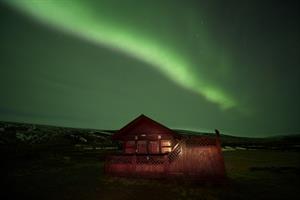 Cottage under northern lights