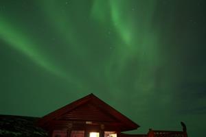 Cottage under northern lights