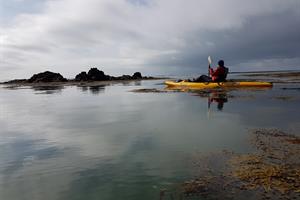 Enjoy paddling on a sit-on-top kayak amidst skerries by the shore
