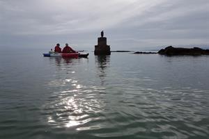 Enjoy paddling on a sit-on-top kayak amidst skerries by the shore