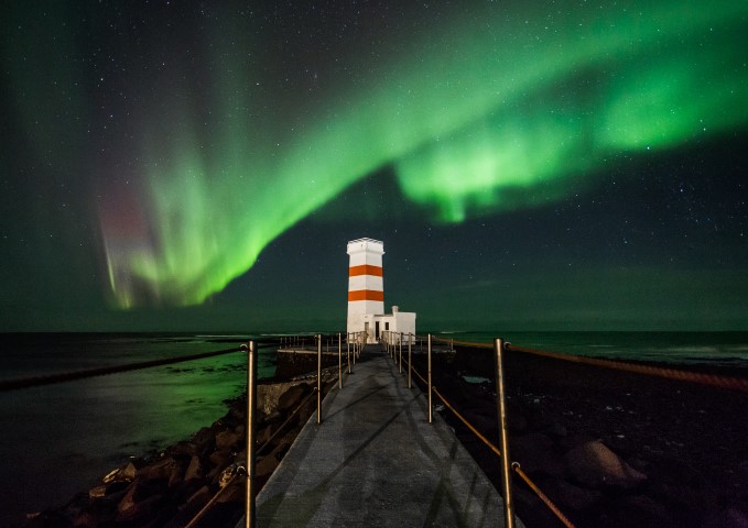 Northen Lights dancing over a lighthouse