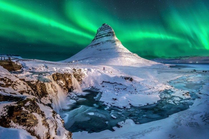 Kirkjufell Mountain under a display of Northern Lights