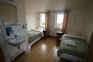 Twin room with shared bathroom