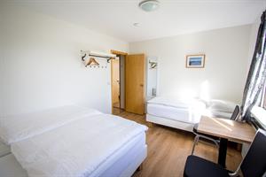 Triple room in the guesthouse with shared bathroom.