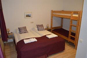 Double room with a bunk bed and shared bathroom