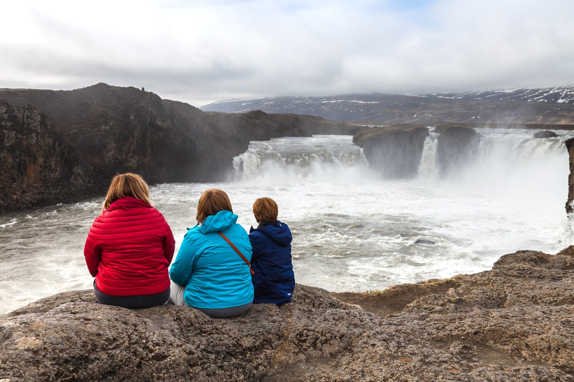 Family looking at Goðafoss Waterfall