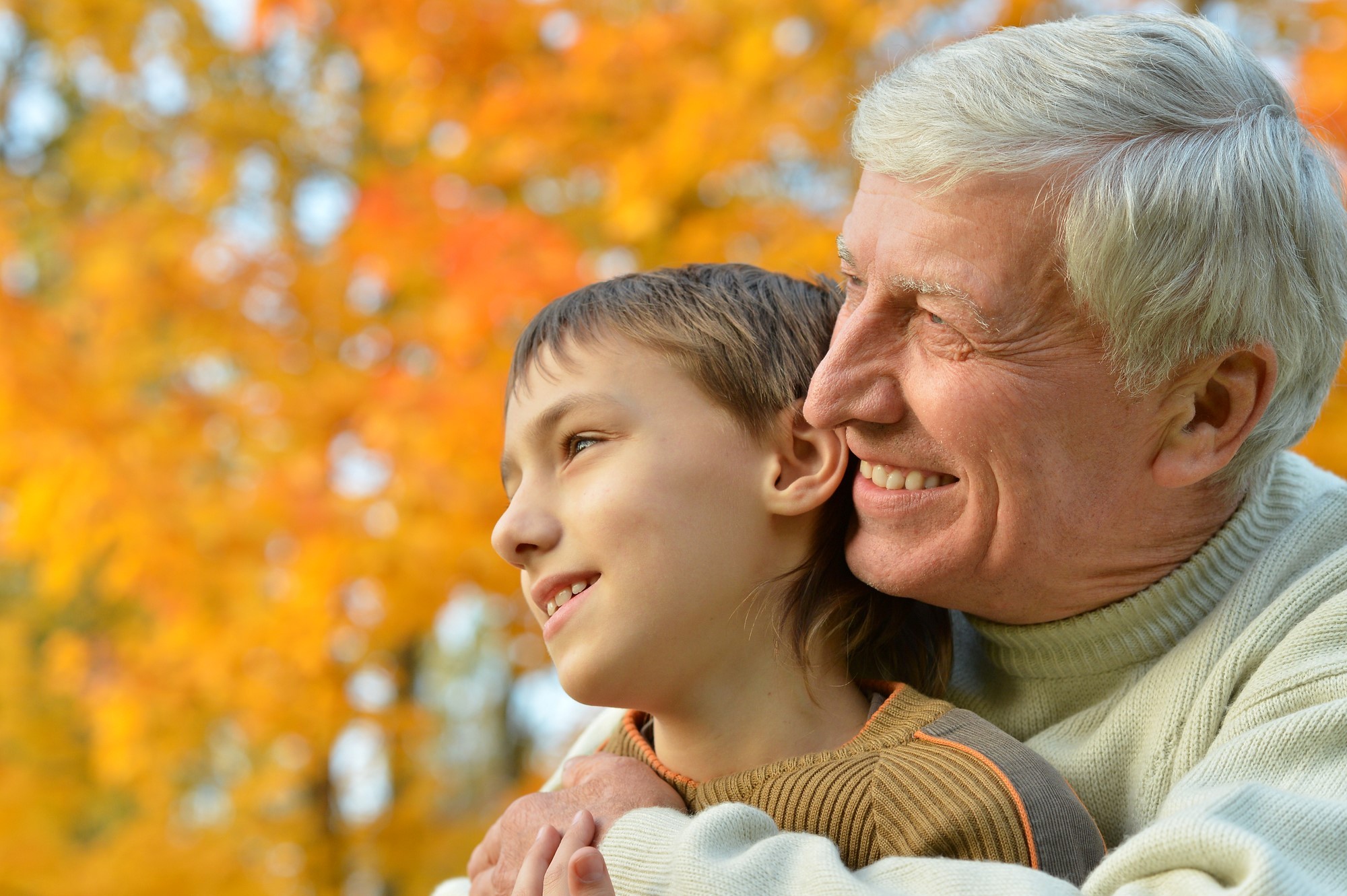 Grandfather lovingly hugging grandson