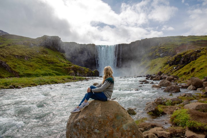 Sitting by a waterfall in Iceland