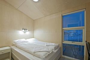 A bedroom with a double bed in a larger sized cottage