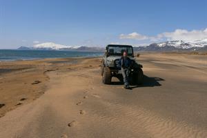 The host Þorkell on a sandy beach by Guesthouse Langaholt